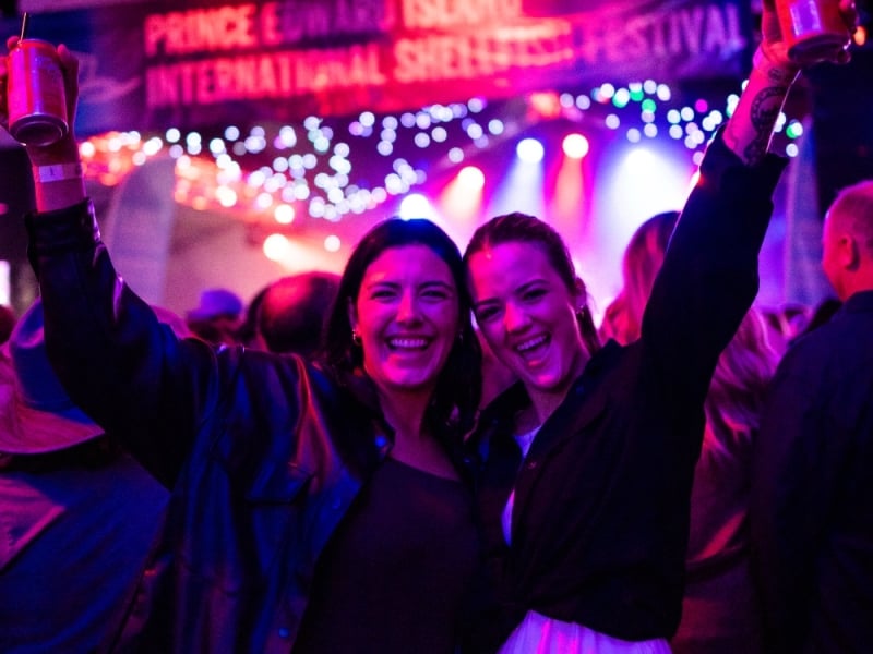 Two people enjoying music at PEI International Shellfish Festival