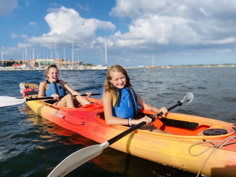 Two young girls in a double kayak on the Charlottetown Harbour