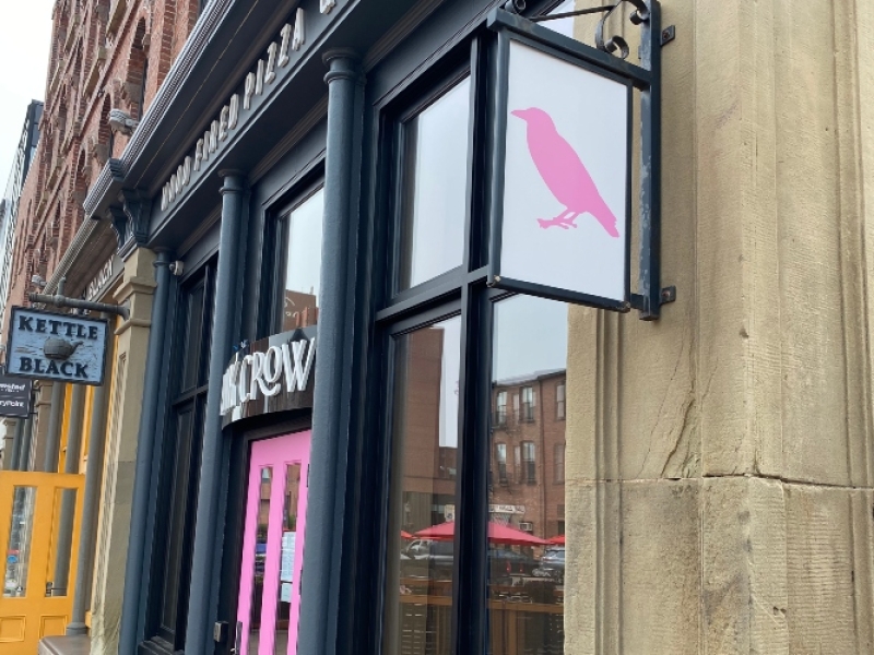 View of front entrance, a pink door, at Pink Crow