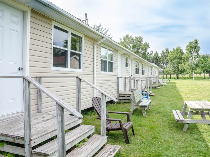 Strip motel with several units together with steps to each unit.