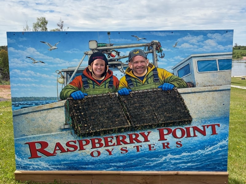 Two people using photo booth at Raspberry Point Oysters
