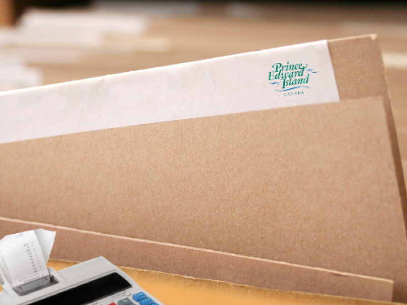 Stock image of file folder with Tourism PEI logo and adding machine