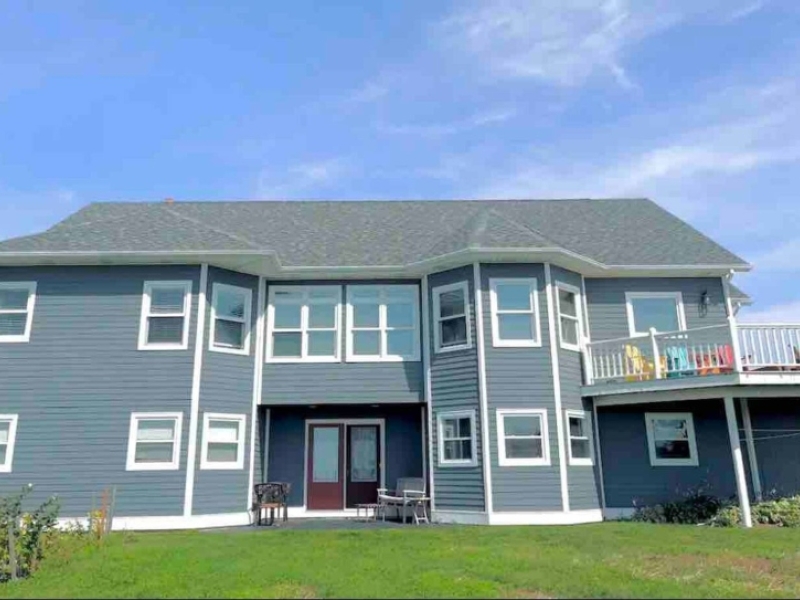 Large two-storey blue home overlooking North Rustico Harbour