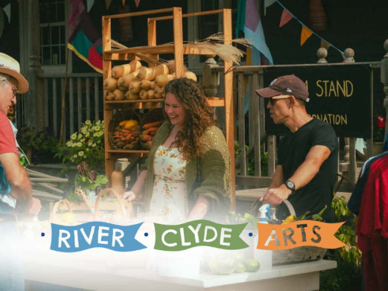 A trio gather at a farm stand in front of The Mill Restaurant at Sharing the Field