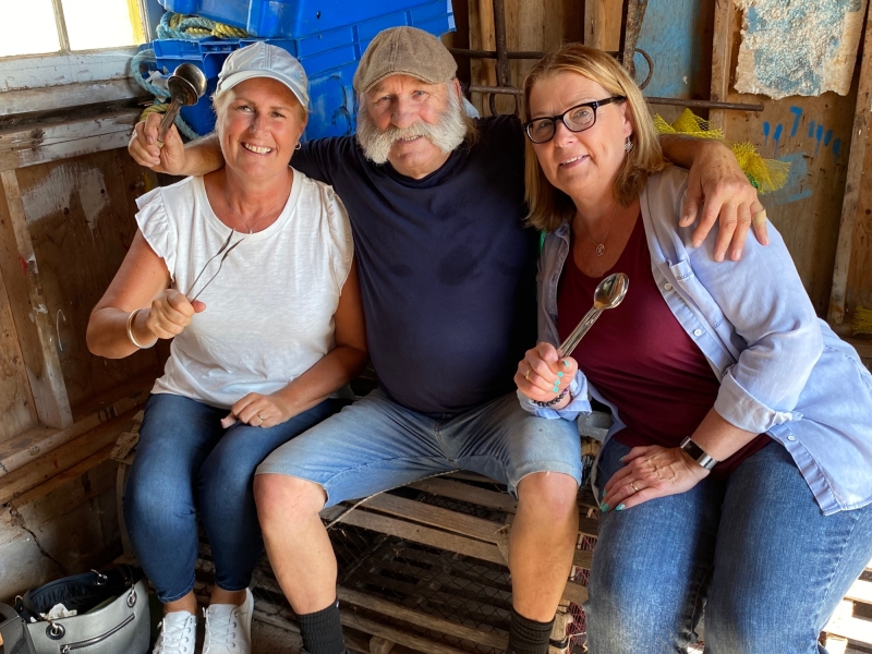 Brendon Peters with visitors in his family fish shack