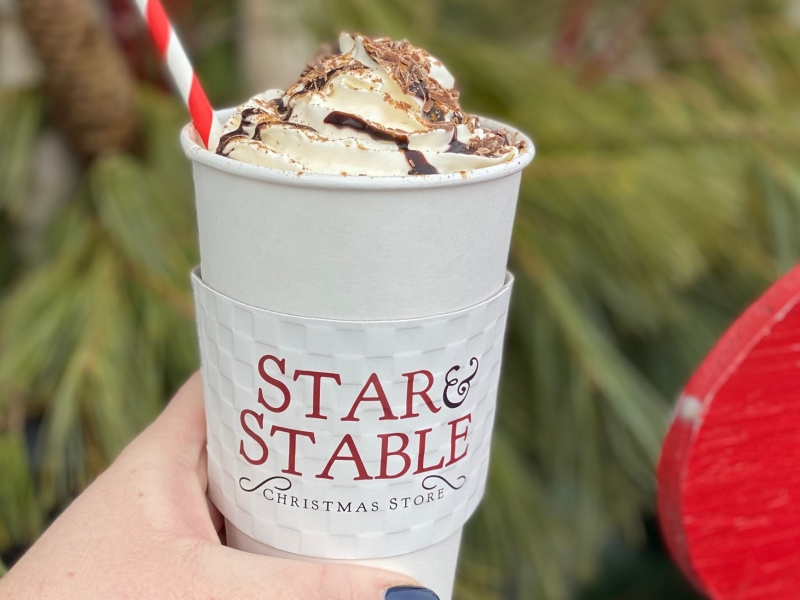 Hand holding a hot chocoate, Star & Stable Christmas Store