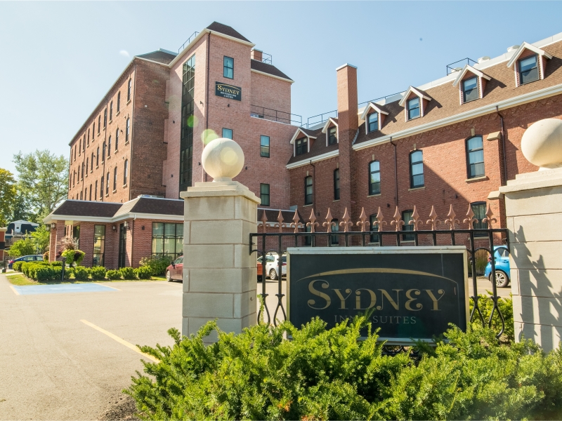 Historic brick building in down Charlottetown with gate entrance and shrubs