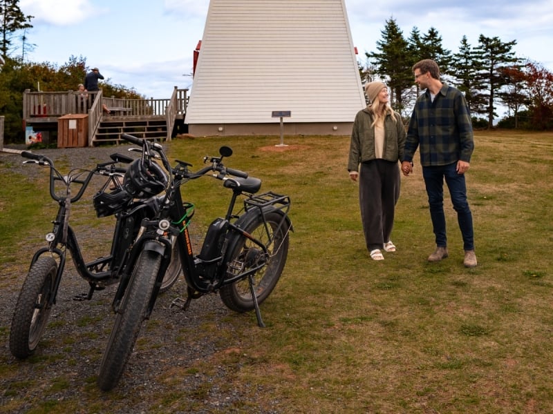 Couple on e-bikes at Cape Bear Lighthouse