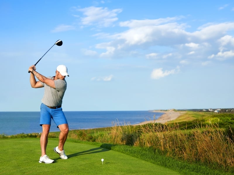 Golf prepares to swing at tee, Crowbush Golf Course