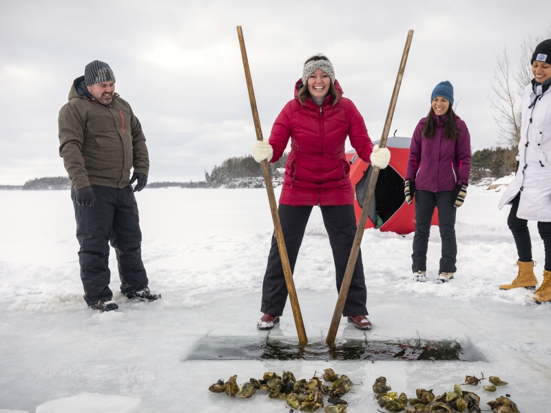 Group of people tonging for oysters in winter, PEI