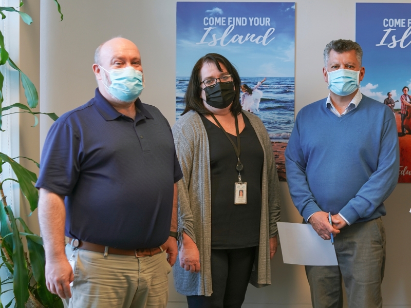 Group shot of three Tourism PEI staff wearing masks