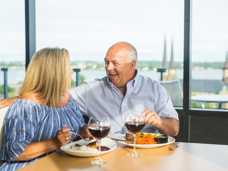 Male and female couple enjoying a meal and glass of wine