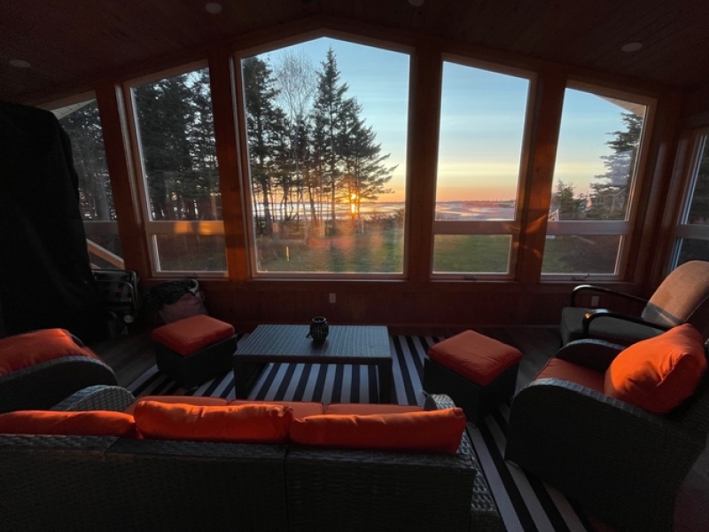 Image of the living room area looking out large windows to the water