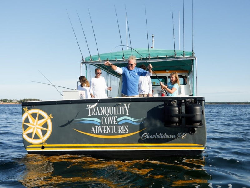 Family onboard fishing vessel fishing mackerel