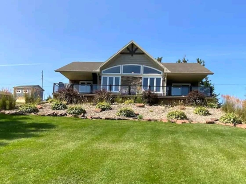 outside photo of large cottage with large windows