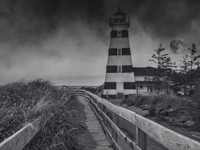 Black & white image of West Point Lighthouse with full moon to the right