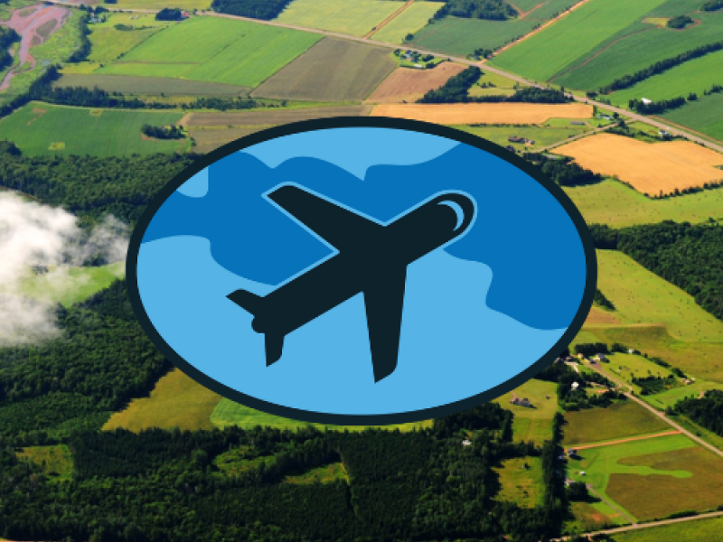 Aerial view of PEI in background with blue graphic image of airplane in oval in foreground