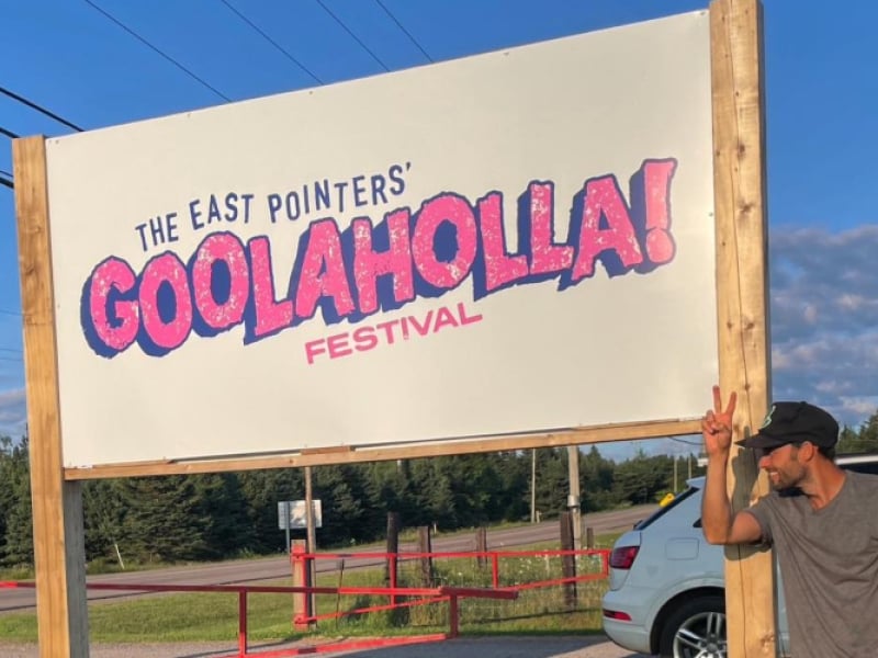 Tim Chaisson standing next to venue sign for Goolaholla!