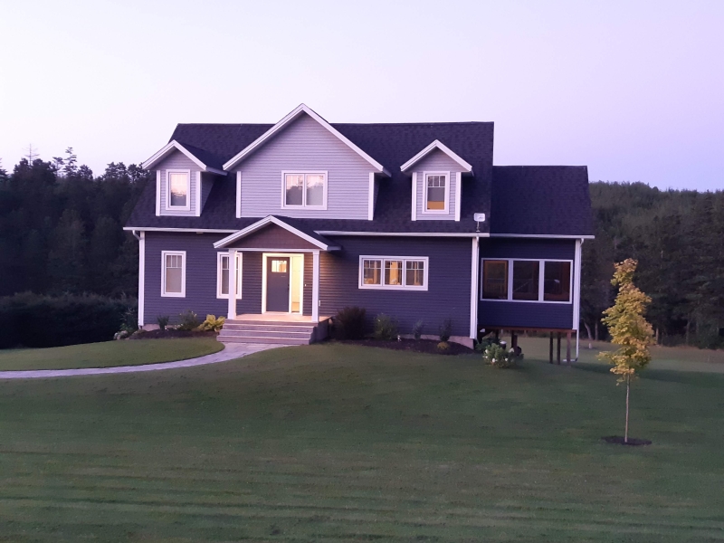 outside view looking at a cape cod style home. 