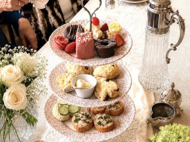 Tiered sweets and sandwiches with fine bone china service