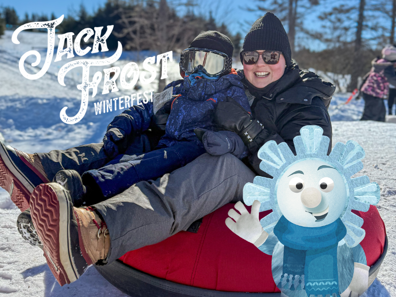 Adult and child on snow tube at Jack Frost Winterfest