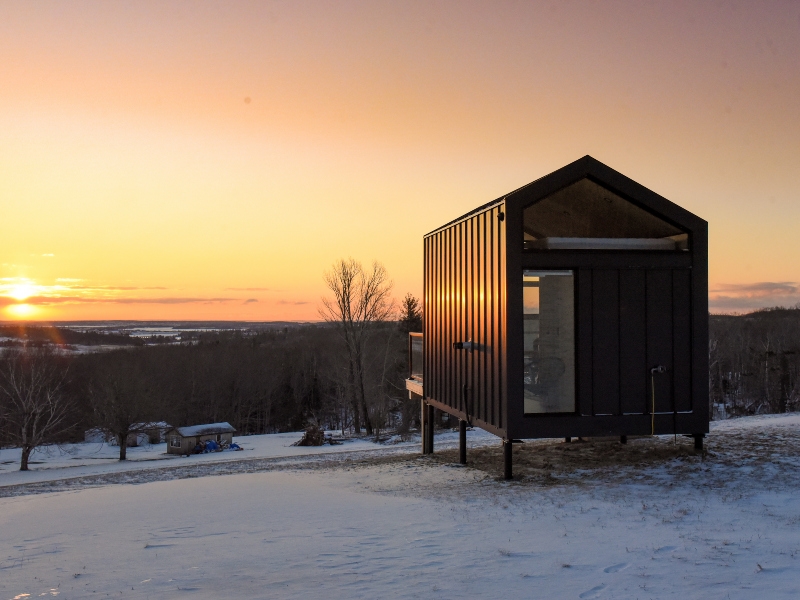 Meridian 360 unit in foreground with sunset over winter landscape in distance