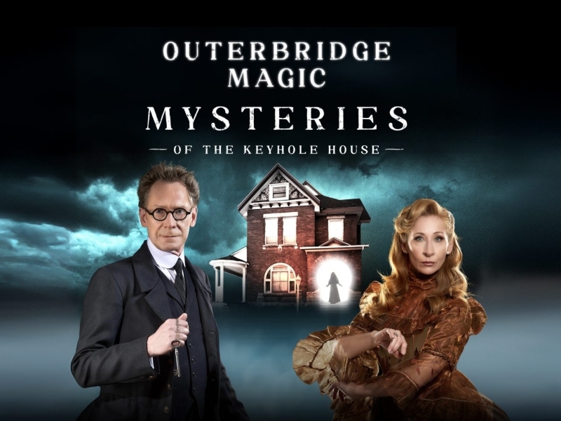 Two actors in front of haunted house