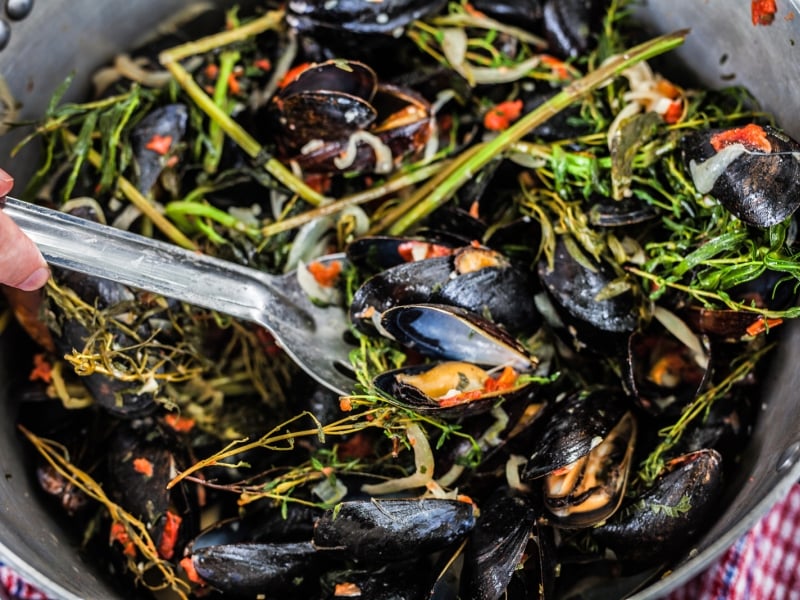 A spoon on a bowl of PEI mussels 