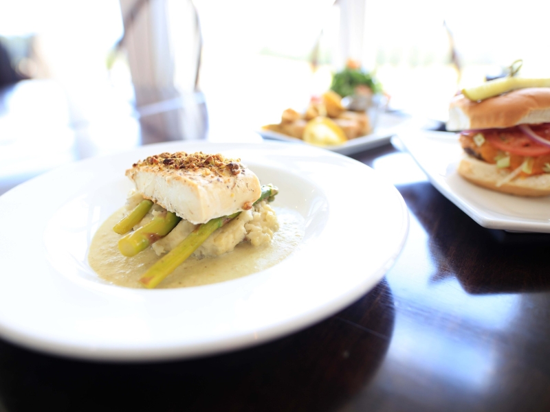 Piper's Restaurant, New Glasgow, PEI Plated haddock with fresh yellow beans and burger to the side