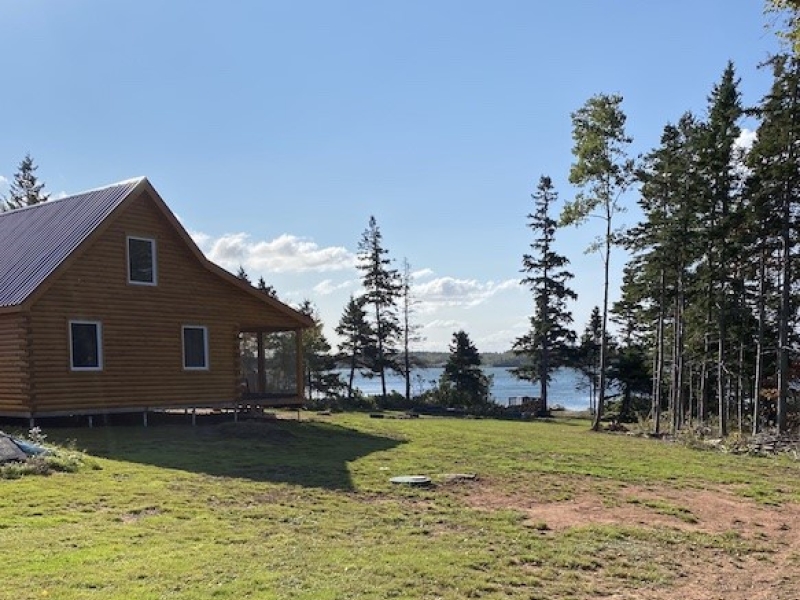 outside photo looking at the side of cottage and waterfront