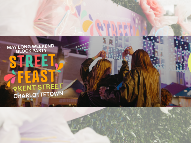 Two people dancing under strung lights on street with STREET FEAST logo to the left