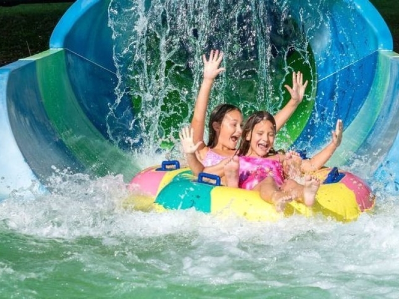 Two girls at end of waterslide at Shining Waters Family Fun Park