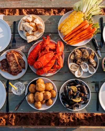 Overhead view of PEI picnic with lobster, potatoes, mussels, chicken, corn. et