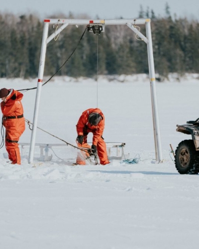 Three fishers on ice for winter mussel harvest