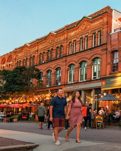 View of couple walking along Victoria Row at dusk in summer