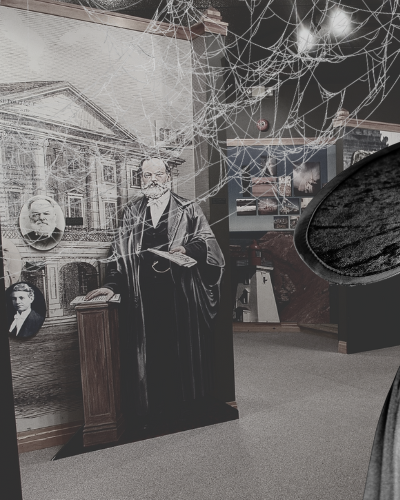 Stock photo of witch in foreground of Acadian Museum exhibits