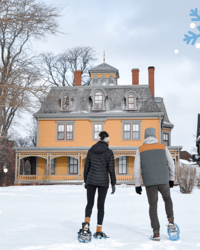 Couple snowshoeing at Beaconsfield Historic House, PEI