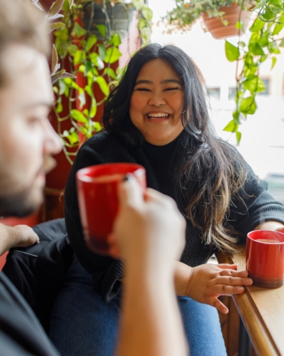 Couple sit in window at local coffee shop