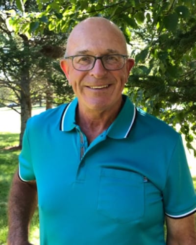 Portrait of Jack Desroches under a tree in summer