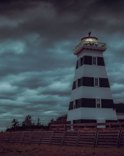Eerie outside view of the West point Lighthouse surrounded by dark clouds