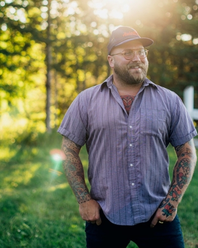Portrait image of Al Douglas standing in front of trees