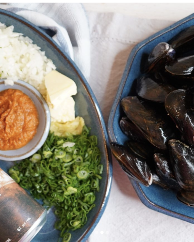 Plated ingredients including beer, cilantro, rice, butter and curry paste and second plate with uncooked PEI Blue Mussels