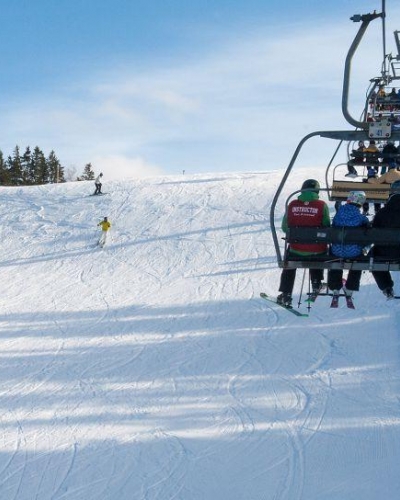 Four people on chair lift