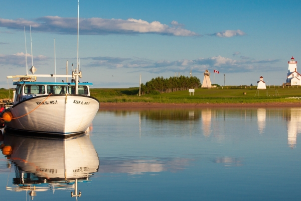 Image of fishing boat in foreground with Wood Islands Provincial Park in background