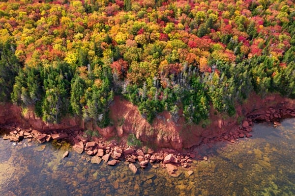 Aerial view of red cliffs and fall foliage, Howe Bay, PEI