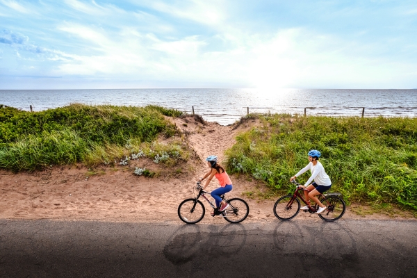 Two cyclists ride along entrance to beach at Panmure Island