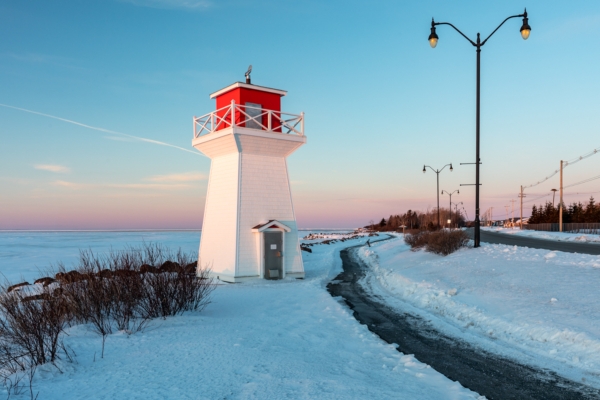 Summerside Lighthouse next to boardwalk at sunset in winter