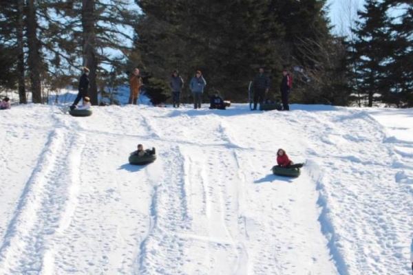 tubing down snow covered hill