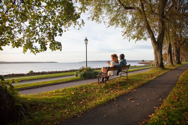 Couple sitting on park bench in Victoria Park