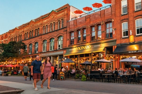 View of couple walking along Victoria Row at dusk in summer